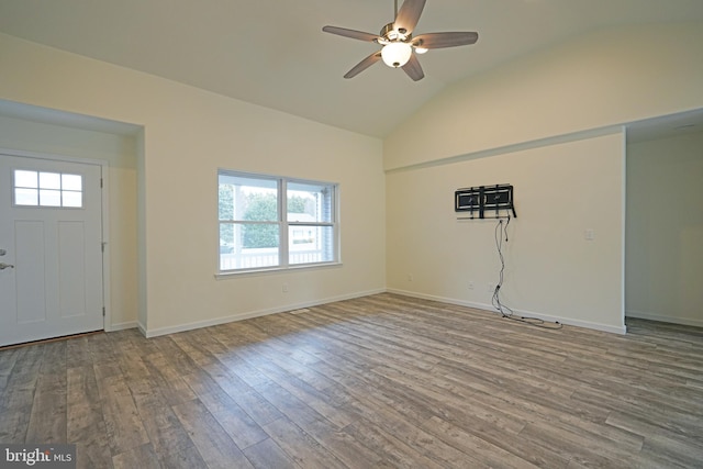 foyer entrance with vaulted ceiling, ceiling fan, wood finished floors, and baseboards