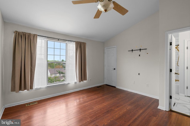 unfurnished room featuring vaulted ceiling, a ceiling fan, dark wood finished floors, baseboards, and visible vents