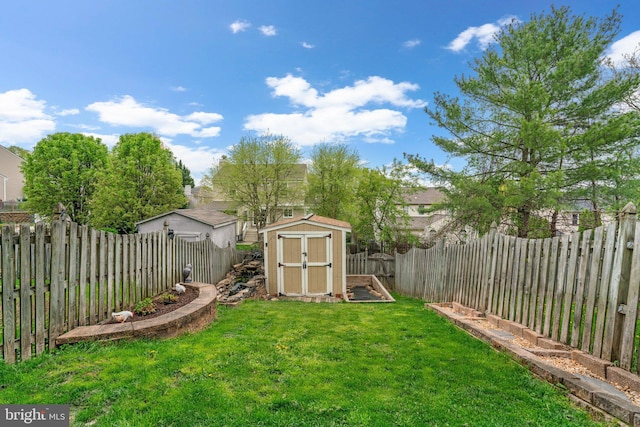 view of yard with a fenced backyard, an outdoor structure, and a storage shed
