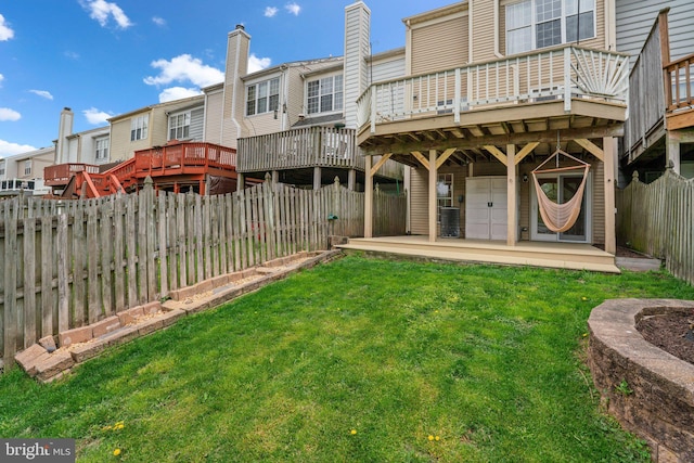 view of yard with a wooden deck, a fenced backyard, cooling unit, and a residential view