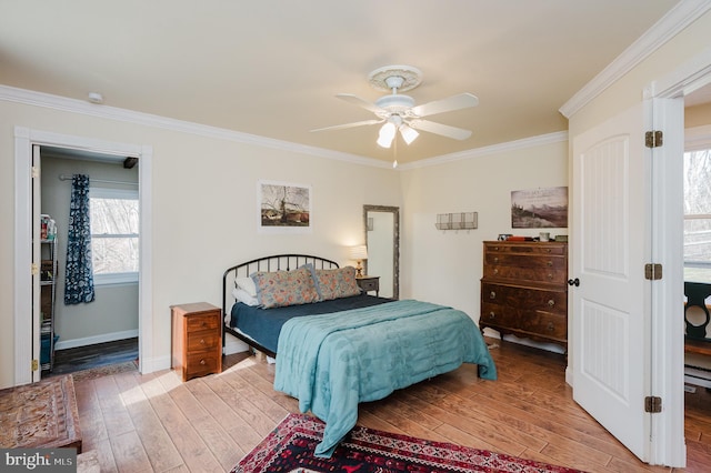 bedroom with light hardwood / wood-style flooring, ceiling fan, and ornamental molding