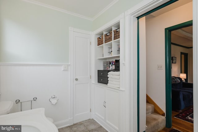 interior space with tile patterned flooring and crown molding