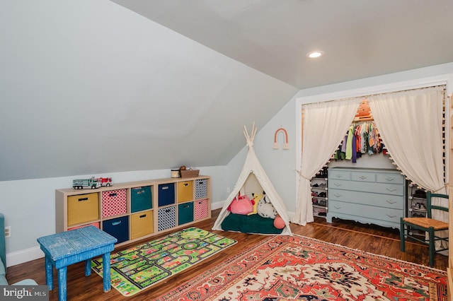 playroom with lofted ceiling and dark hardwood / wood-style flooring