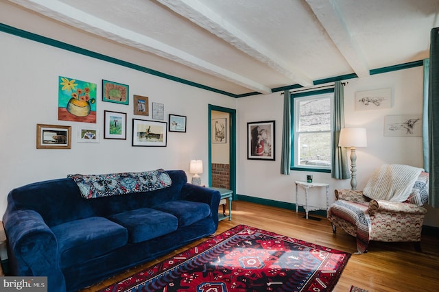 living room featuring beamed ceiling and hardwood / wood-style floors