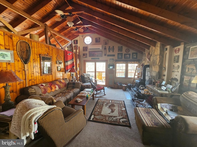 carpeted living room featuring beam ceiling, high vaulted ceiling, wooden ceiling, and wooden walls