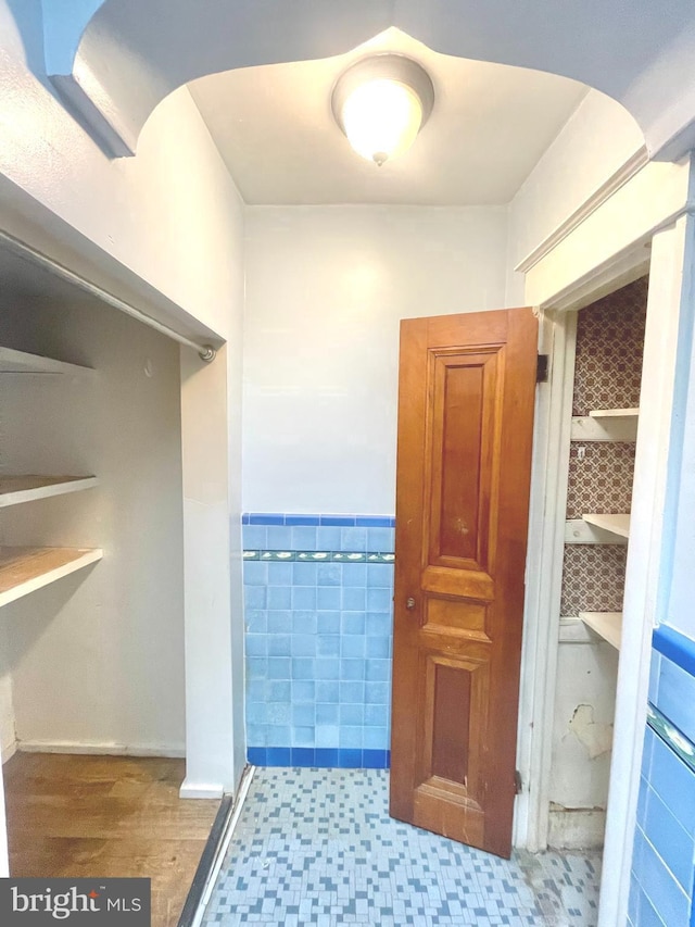 bathroom with tile walls