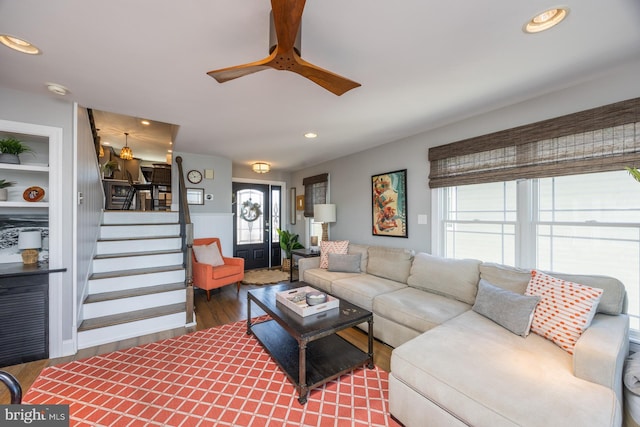 living room with wood-type flooring and ceiling fan