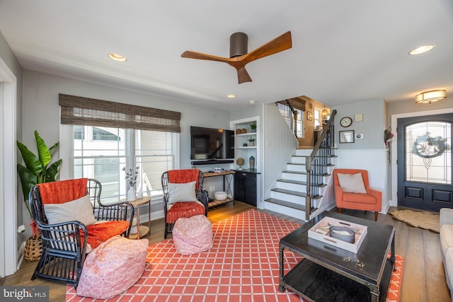 living room featuring ceiling fan and hardwood / wood-style floors