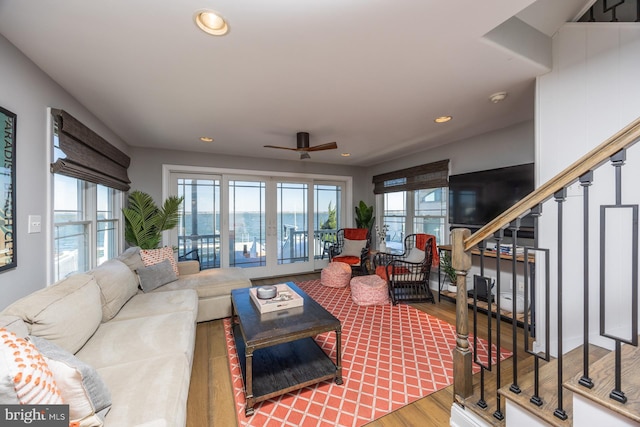 living room with hardwood / wood-style flooring and ceiling fan