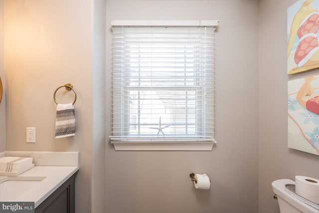 bathroom with vanity, a wealth of natural light, and toilet