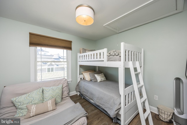 bedroom with dark hardwood / wood-style floors