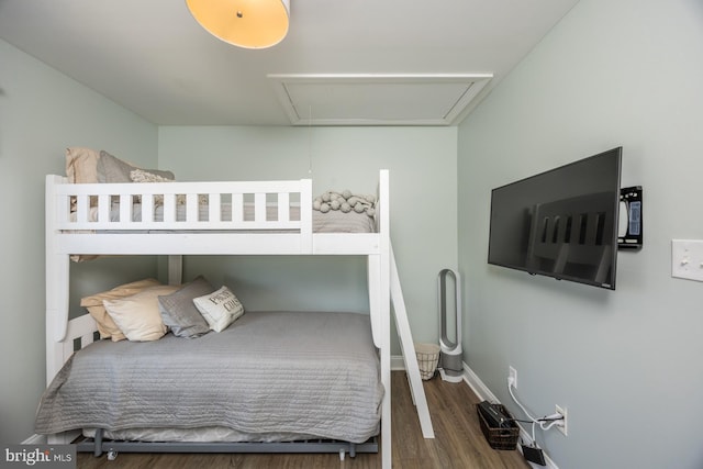 bedroom with dark hardwood / wood-style floors