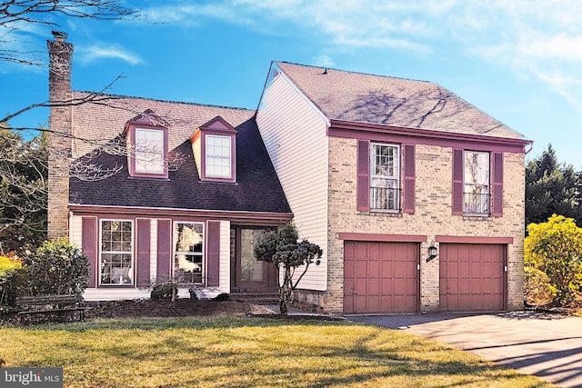 view of front of home with a front lawn and a garage