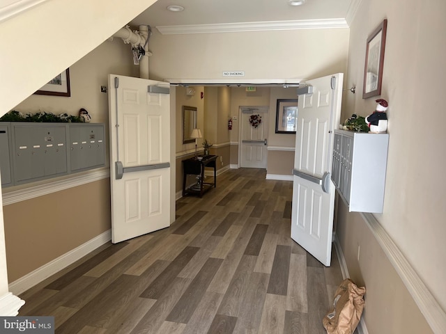 corridor with crown molding, mail boxes, and dark hardwood / wood-style flooring