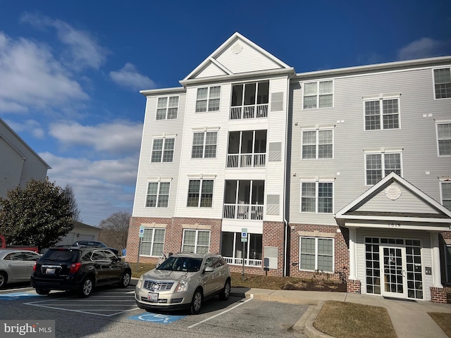 view of property featuring uncovered parking