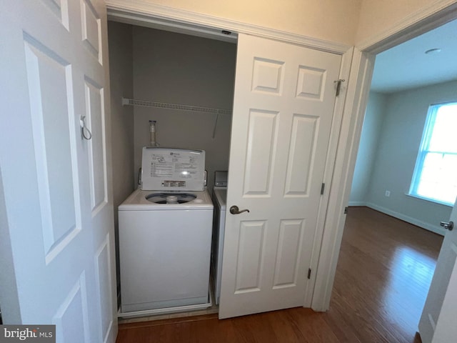 laundry area with wood finished floors, laundry area, and washer / clothes dryer