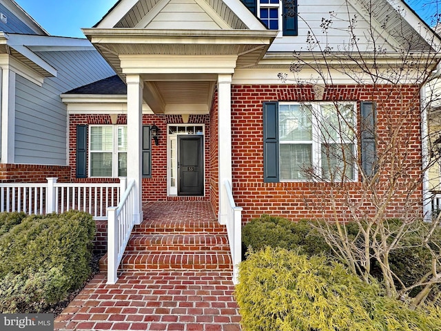 doorway to property with brick siding