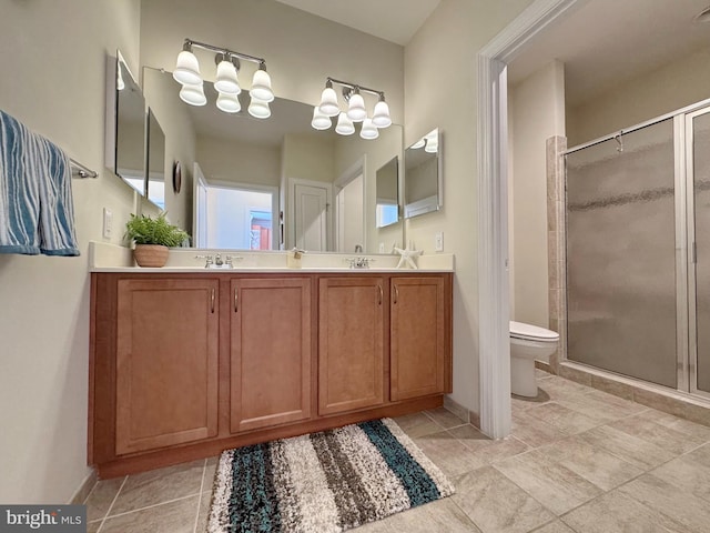 bathroom featuring a chandelier, a shower stall, toilet, and a sink