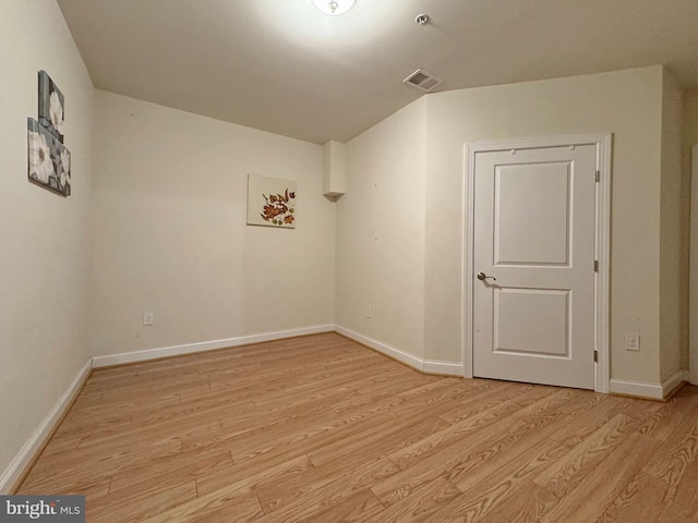 unfurnished room featuring baseboards and light wood finished floors