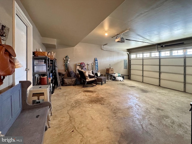 garage featuring electric panel and a garage door opener