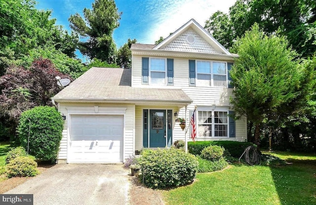 view of front facade with a garage, driveway, and a front yard