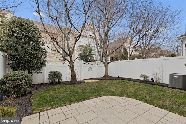 view of yard featuring a patio area, central AC, and a fenced backyard