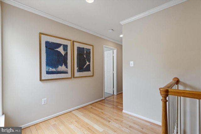 corridor featuring wood finished floors, baseboards, recessed lighting, ornamental molding, and an upstairs landing