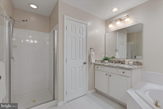 full bath featuring tile patterned floors, a shower stall, a relaxing tiled tub, baseboards, and vanity