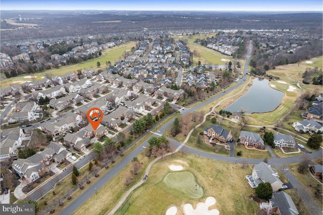 aerial view with golf course view, a water view, and a residential view