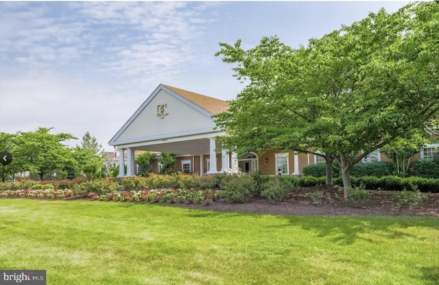 greek revival inspired property featuring a front yard