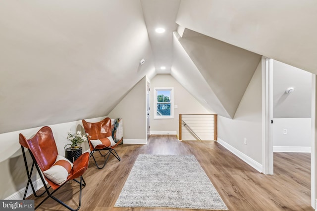 bonus room featuring light wood-type flooring and vaulted ceiling