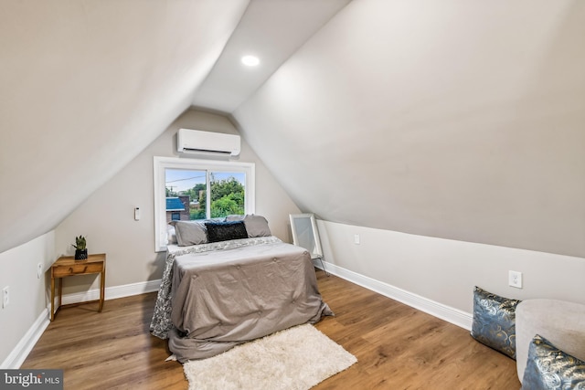 bedroom featuring an AC wall unit, hardwood / wood-style flooring, and vaulted ceiling