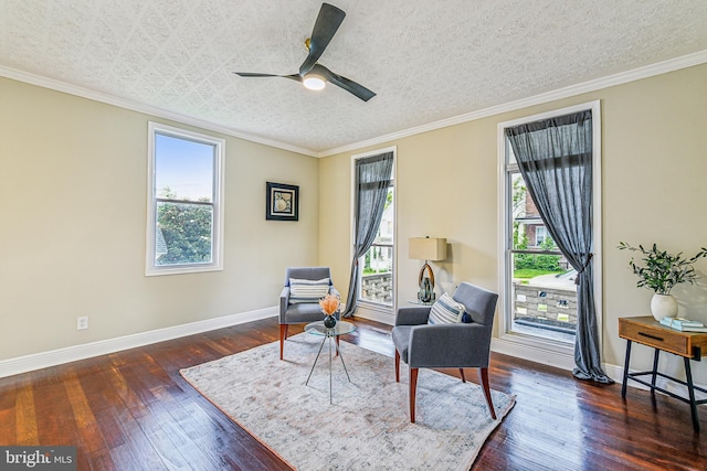 living area featuring ceiling fan, a textured ceiling, crown molding, and dark hardwood / wood-style floors