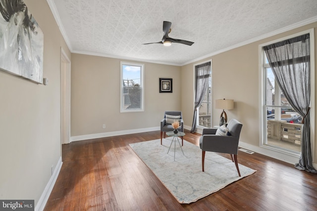 sitting room with crown molding, dark hardwood / wood-style floors, and a textured ceiling