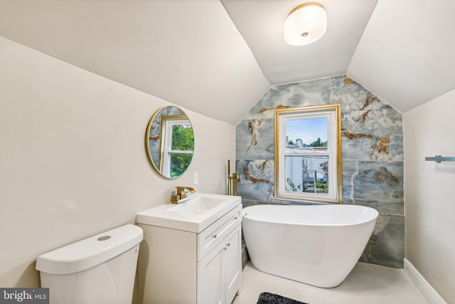 bathroom featuring vaulted ceiling, tile walls, vanity, a washtub, and toilet