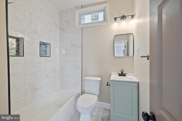 full bathroom featuring vanity, tiled shower / bath, and toilet