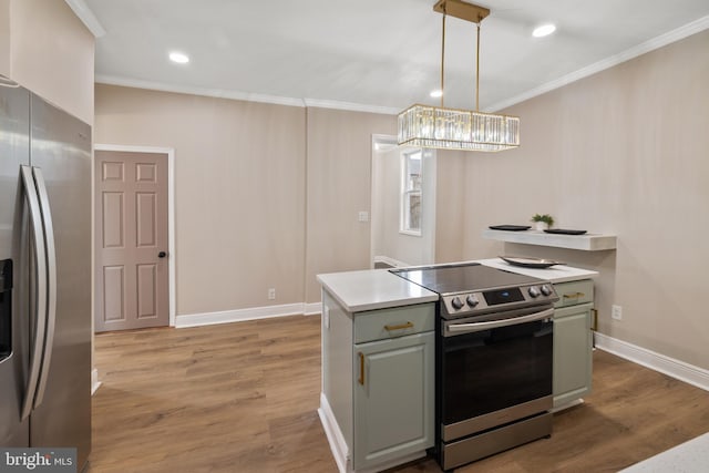 kitchen with light hardwood / wood-style floors, stainless steel appliances, pendant lighting, and crown molding