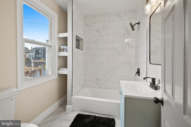 full bathroom featuring toilet, vanity, and tiled shower / bath