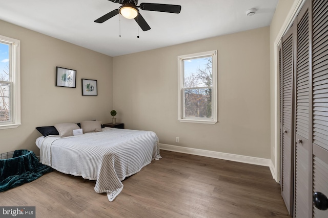 bedroom featuring a closet, hardwood / wood-style floors, and ceiling fan