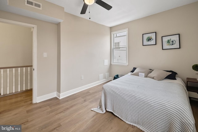 bedroom with ceiling fan and light hardwood / wood-style floors