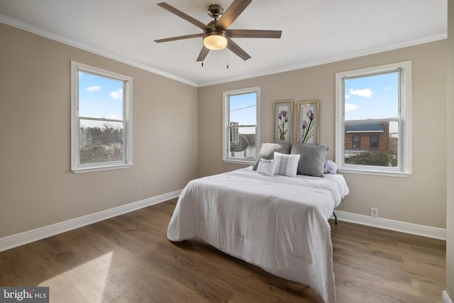 bedroom featuring crown molding, dark hardwood / wood-style flooring, and ceiling fan