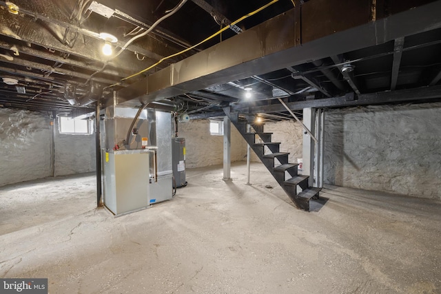 basement with water heater and heating unit