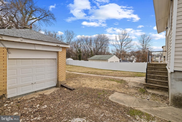 view of yard with a garage and an outdoor structure