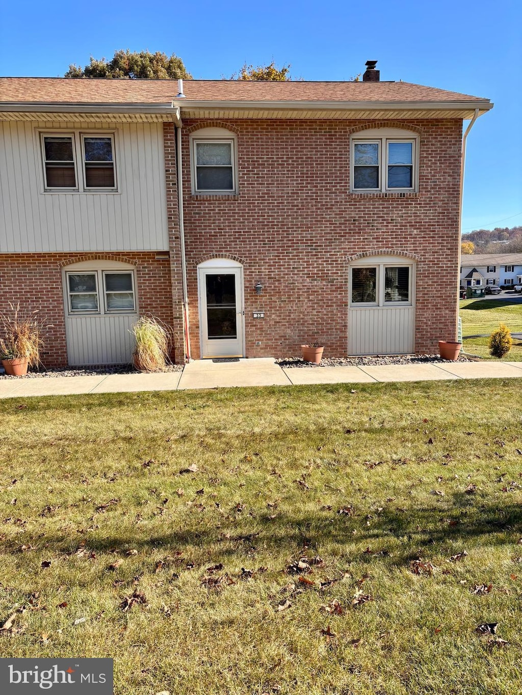 rear view of property with a yard