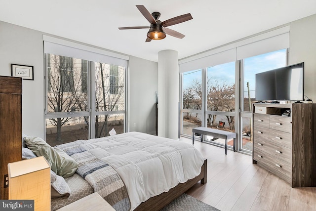 bedroom with light wood-style floors and a ceiling fan