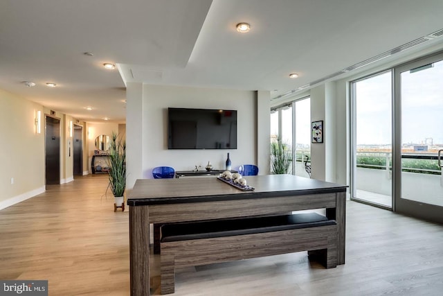 dining area featuring baseboards and light wood-style floors