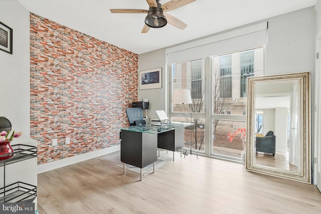 home office with baseboards, a ceiling fan, a wealth of natural light, and wood finished floors