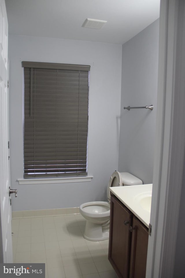 bathroom featuring toilet and vanity