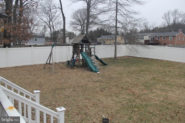 view of jungle gym with a fenced backyard, a residential view, and a yard