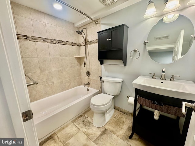 bathroom featuring toilet, vanity, bathtub / shower combination, and visible vents